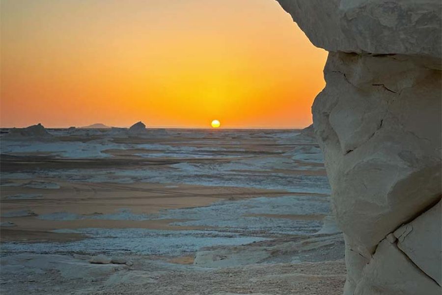 The unique chalk-white rock formations of the White Desert bathed in the soft, warm light of a desert sunrise near Bahariya Oasis